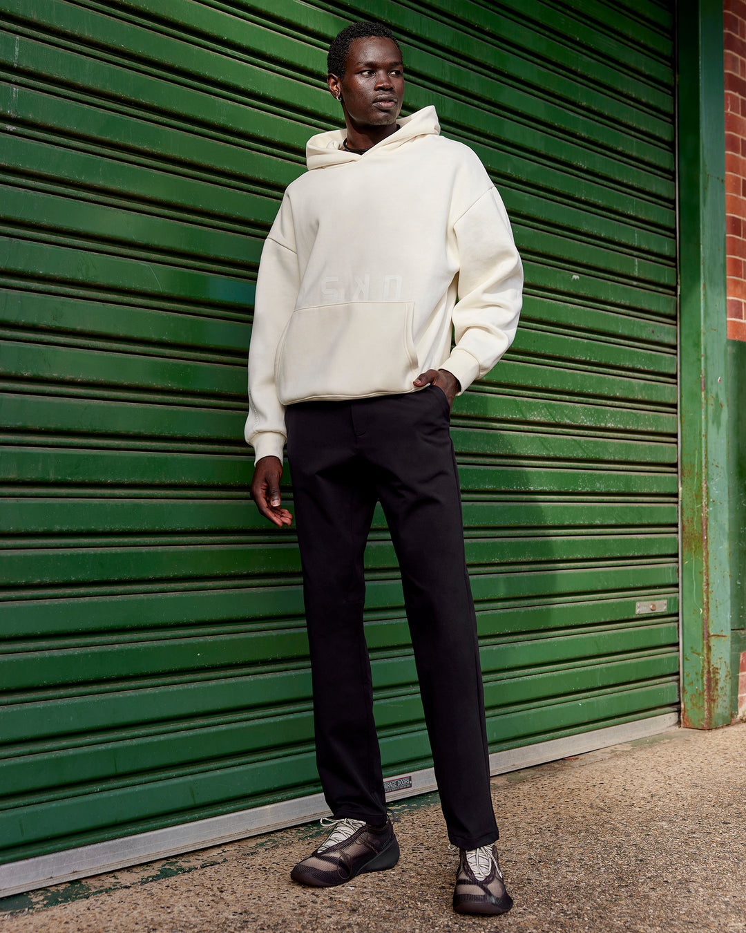Man wearing Shadow Mode Oversized Hoodie - Off White | Model:Mabyro | Size:M
