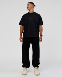 Man wearing Static Grit Baggy Track Pant - Black-Alloy | Model:Jaiden | Size:M