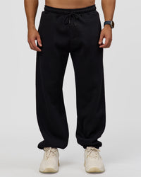 Man wearing Static Grit Baggy Track Pant - Black-Alloy | Model:Jaiden | Size:M