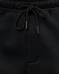 Man wearing Static Grit Baggy Track Pant - Black-Alloy | Model:Jaiden | Size:M