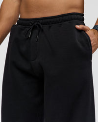 Man wearing Static Grit Baggy Track Pant - Black-Alloy | Model:Jaiden | Size:M