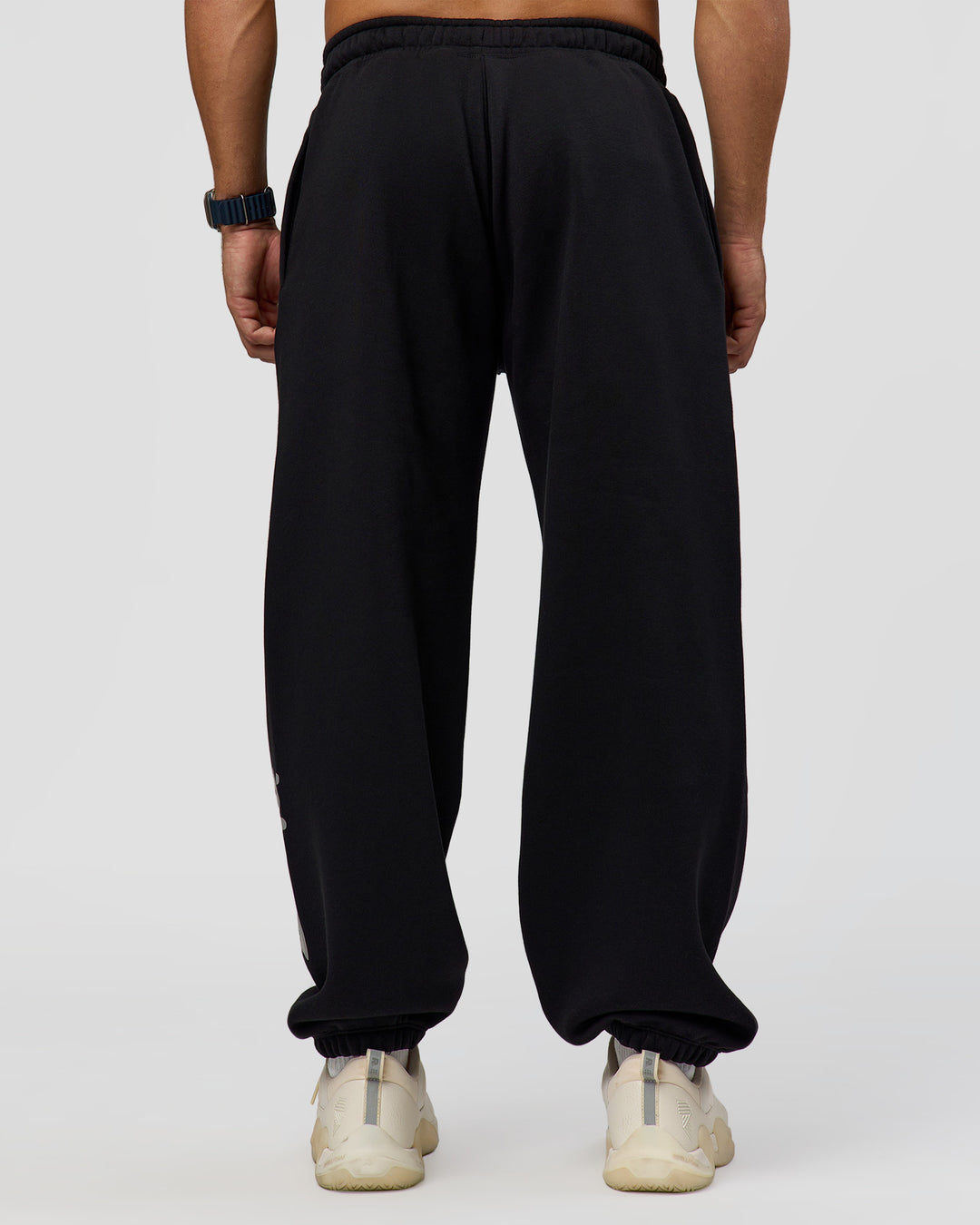 Man wearing Static Grit Baggy Track Pant - Black-Alloy | Model:Jaiden | Size:M