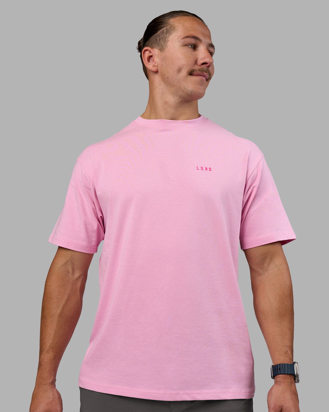 Man wearing 1% Better Value Series FLXCotton Tee Oversize - Bubblegum-Ultra Pink | Model:Jaiden | Size:M