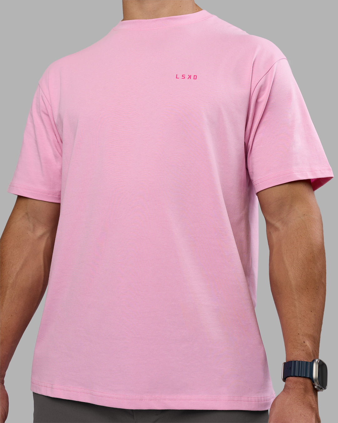 Man wearing 1% Better Value Series FLXCotton Tee Oversize - Bubblegum-Ultra Pink | Model:Jaiden | Size:M