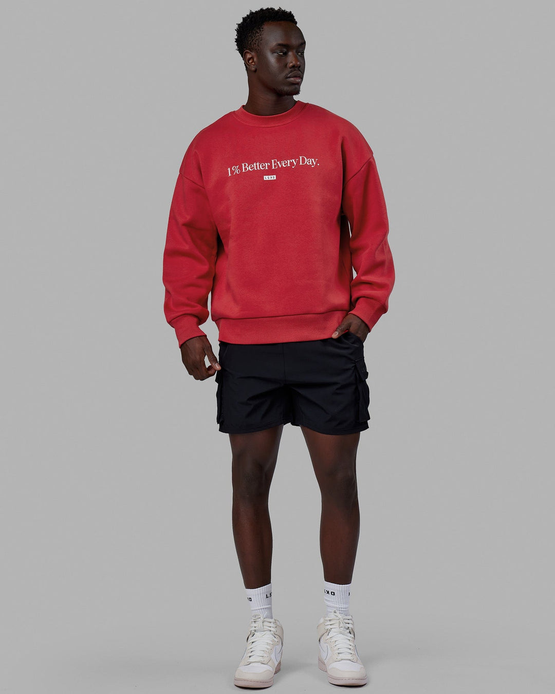 Man wearing Unisex 1% Better Sweater Oversize - Cardinal