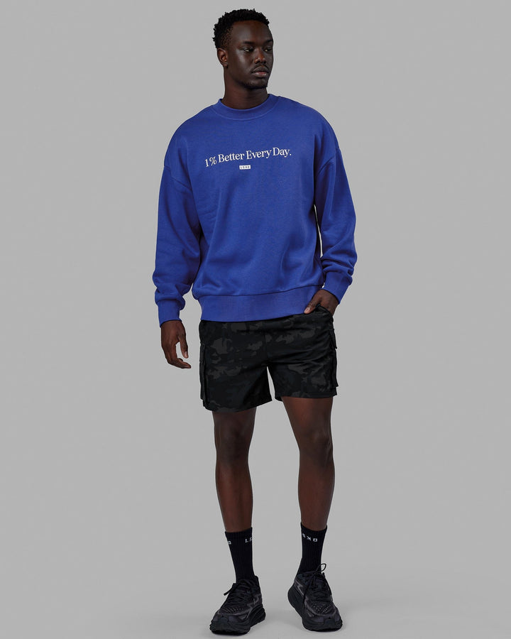 Man wearing Unisex 1% Better Sweater Oversize - Power Cobalt-White