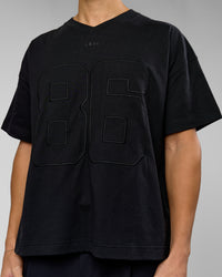 Man wearing 86 V-Neck Oversized Tee - Black-Black | Model:Leandro | Size:M