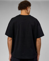 Man wearing 86 V-Neck Oversized Tee - Black-Black | Model:Leandro | Size:M