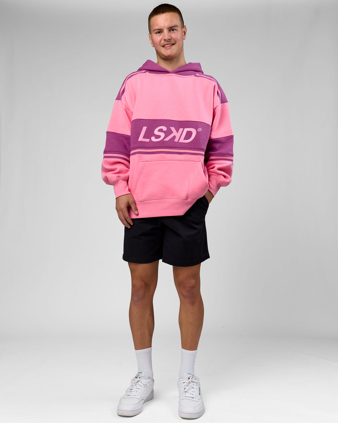 Man wearing A-Team Oversized Hoodie - Candy Pink-Boysenberry | Model:Arran | Size:M