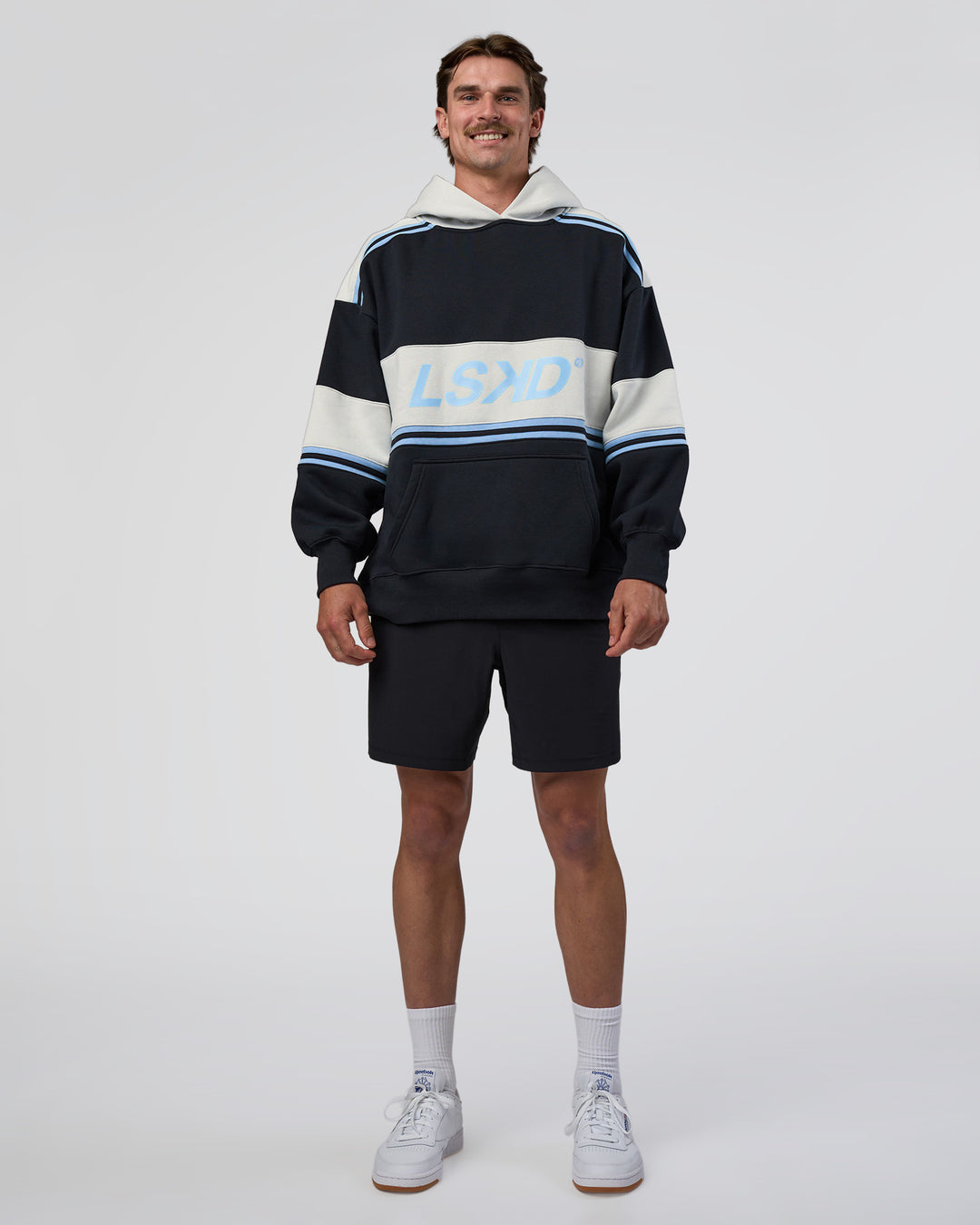 Man wearing A-Team Oversized Hoodie - Caviar-Open Air | Model:Konnor | Size:M