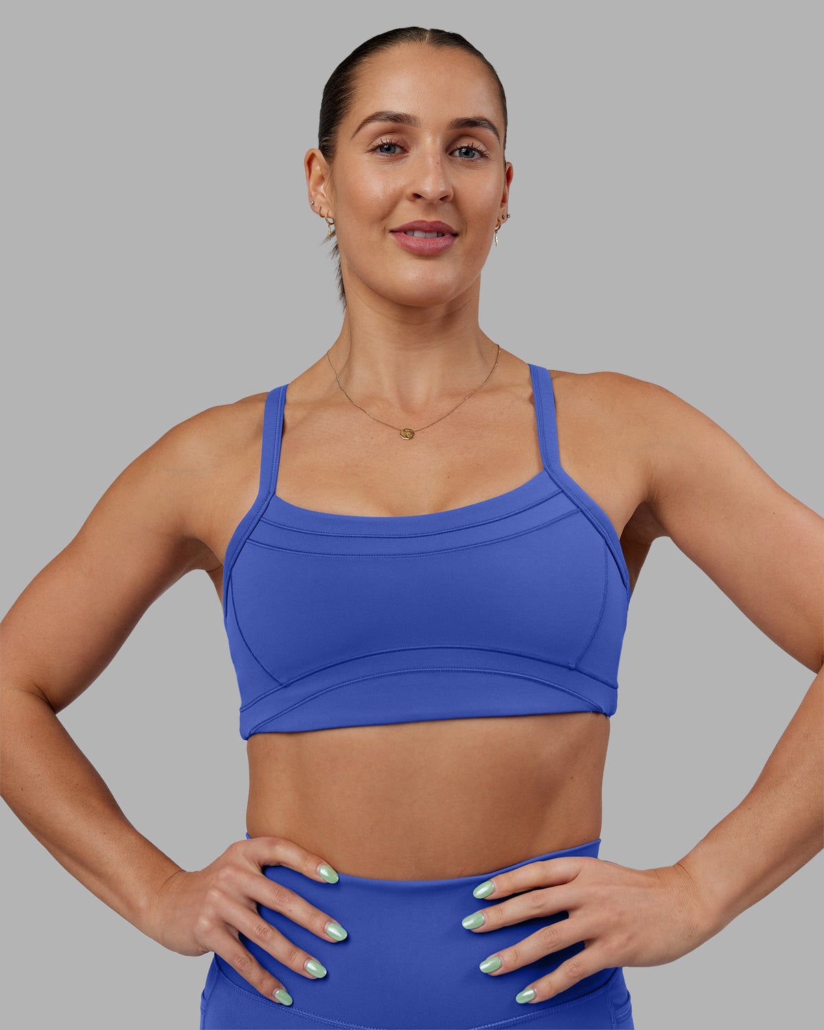 Woman wearing Abs Ignite Sports Bra - Power Cobalt | Model:Abbey | Size:M