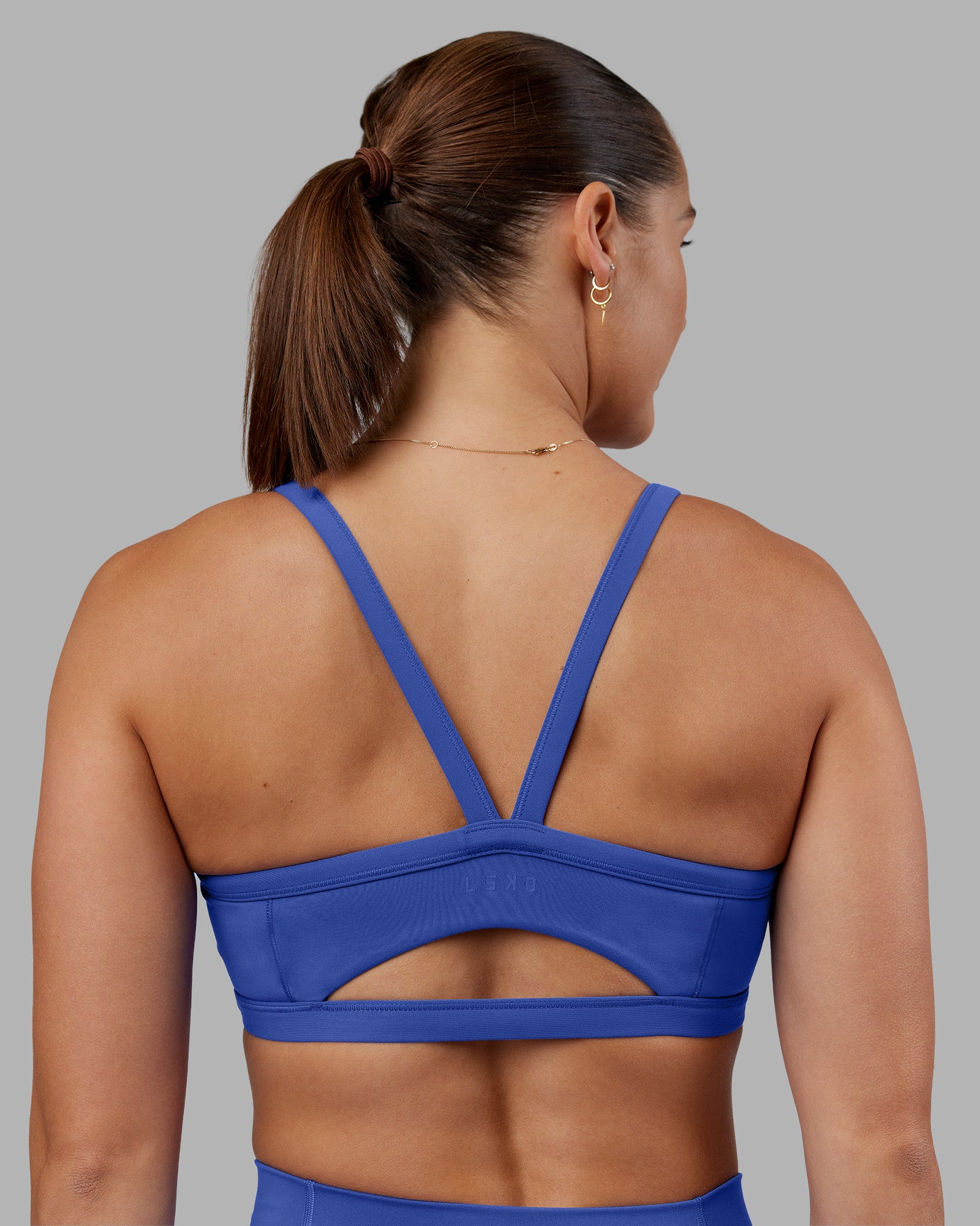 Woman wearing Abs Ignite Sports Bra - Power Cobalt | Model:Abbey | Size:M