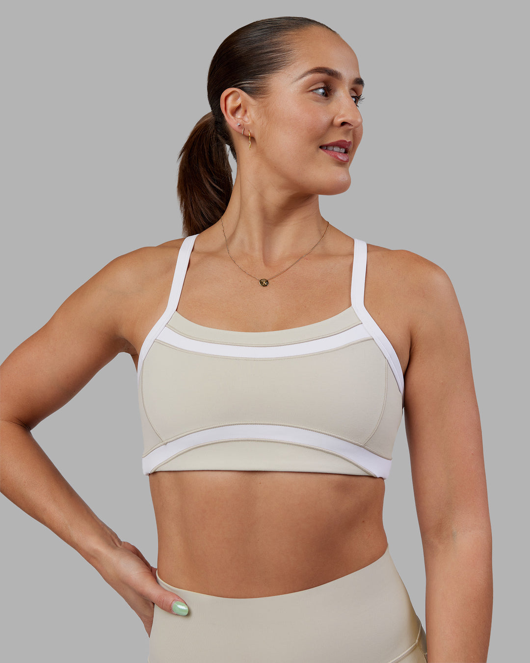 Woman wearing Abs Ignite Sports Bra - Shale Beige-White | Model:Abbey | Size:M