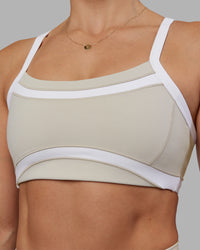 Woman wearing Abs Ignite Sports Bra - Shale Beige-White | Model:Abbey | Size:M