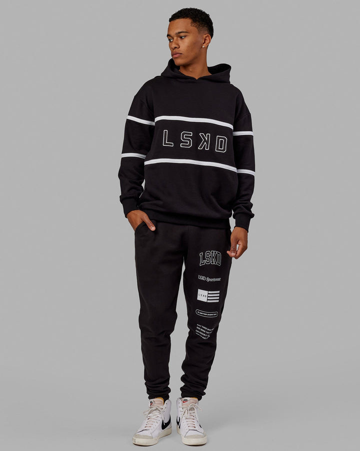 Man wearing Unisex Academy Track Pant - Black