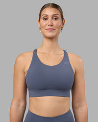 Woman wearing Accelerate Sports Bra - Night Shadow | Set:true | Angle:front | Model:Amy | Size:M