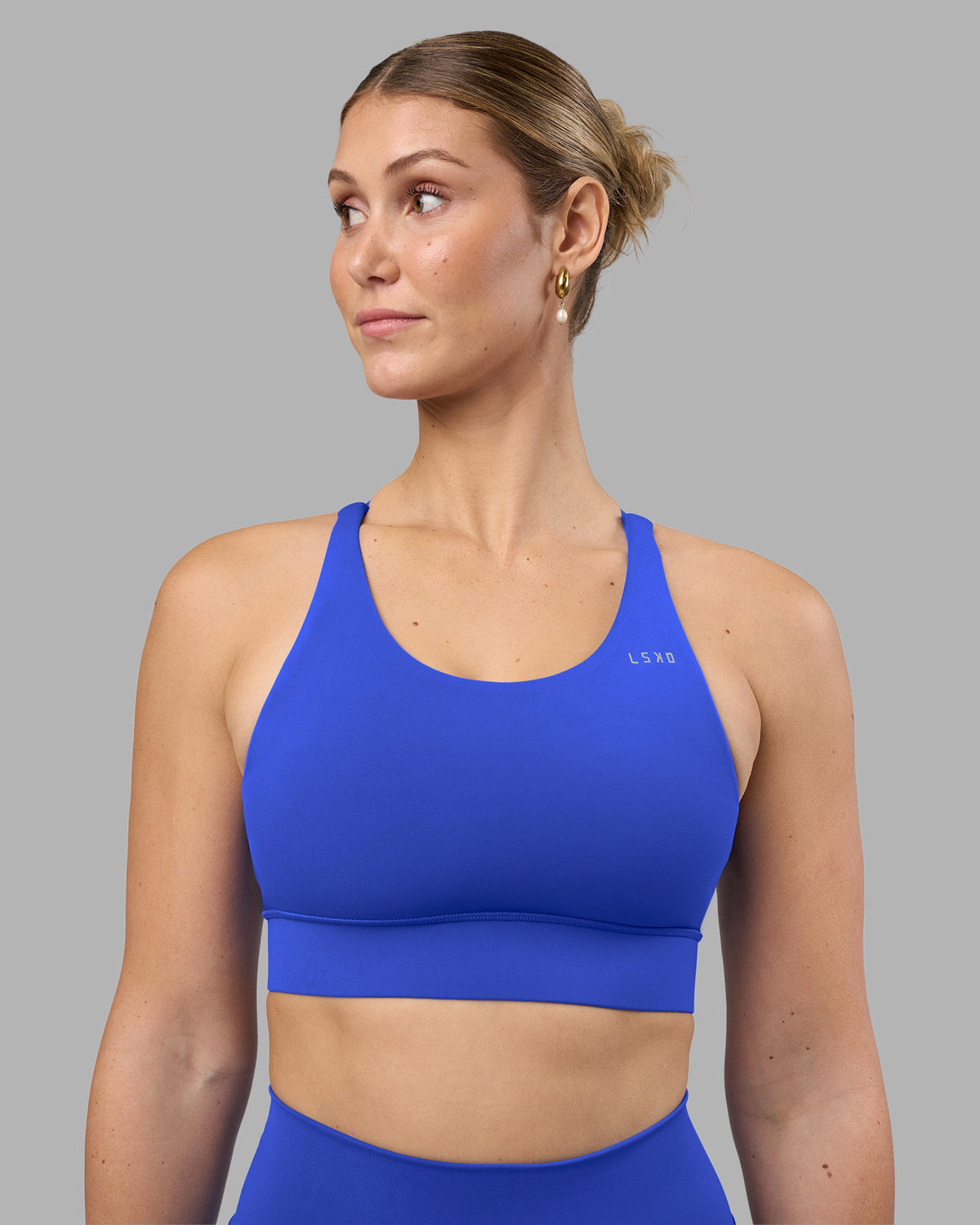 Woman wearing Accelerate Sports Bra - Power Cobalt | Model:Amy | Size:M