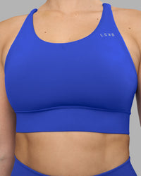 Woman wearing Accelerate Sports Bra - Power Cobalt | Model:Amy | Size:M