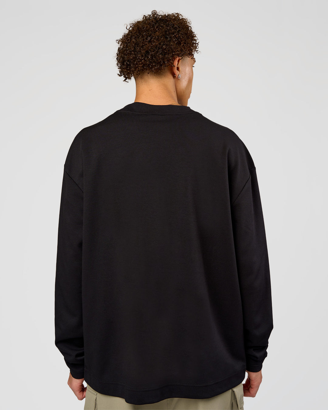 Man wearing AfterDark ZeroCrease Long Sleeve Tee - Black | Model:Leandro | Size:M