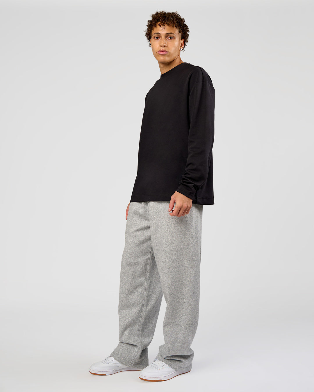 Man wearing AfterDark ZeroCrease Long Sleeve Tee - Black | Model:Leandro | Size:M