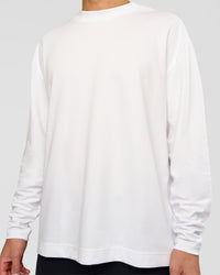 Man wearing AfterDark ZeroCrease Long Sleeve Tee - White | Model:Leandro | Size:M