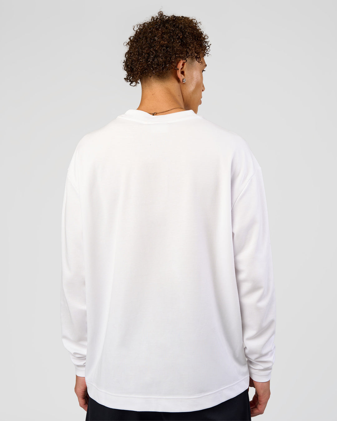 Man wearing AfterDark ZeroCrease Long Sleeve Tee - White | Model:Leandro | Size:M