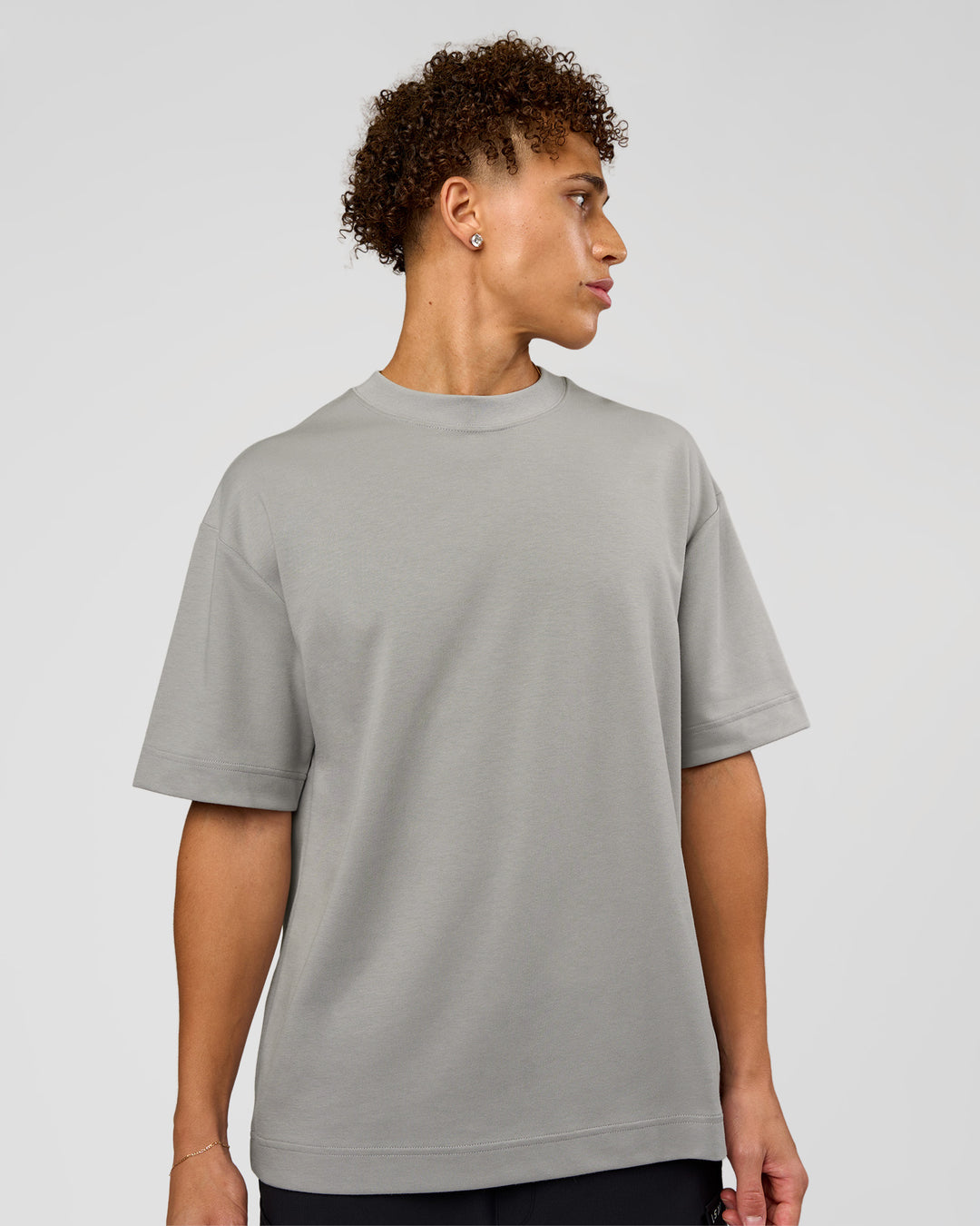Man wearing AfterDark ZeroCrease Oversized Tee - Alloy | Model:Leandro | Size:M