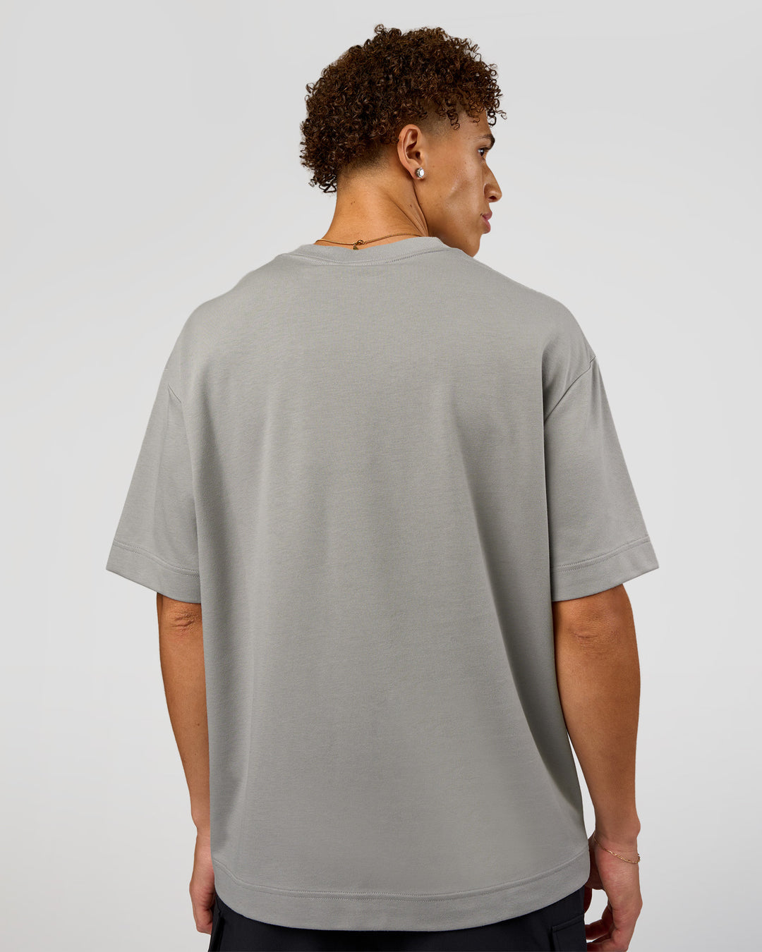 Man wearing AfterDark ZeroCrease Oversized Tee - Alloy | Model:Leandro | Size:M