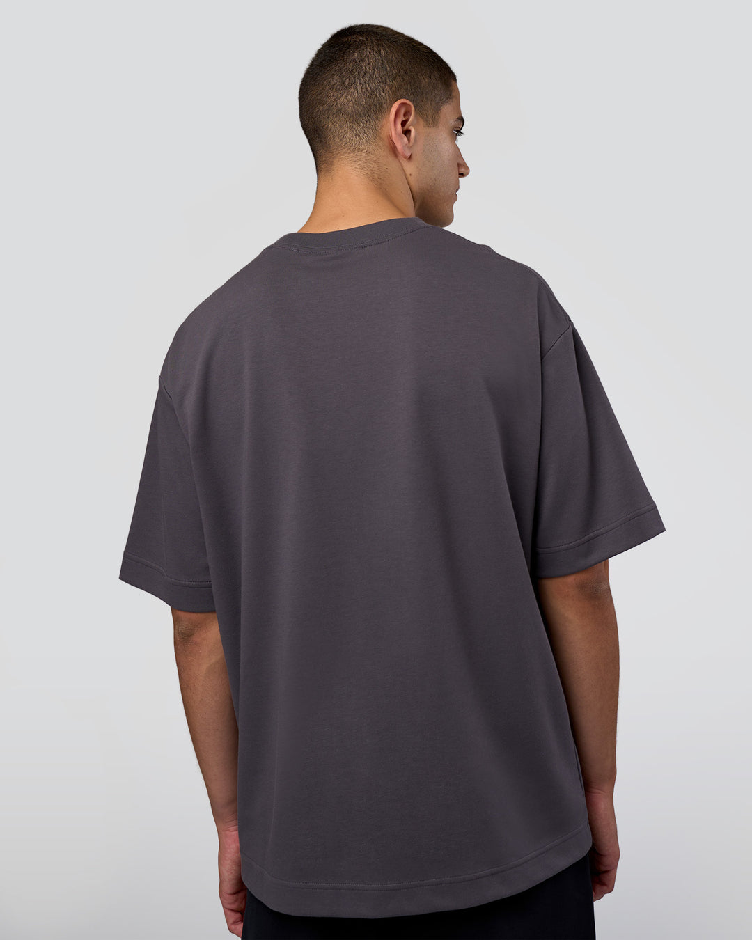 Man wearing AfterDark ZeroCrease Oversized Tee - Dark Storm | Model:Zoran | Size:M