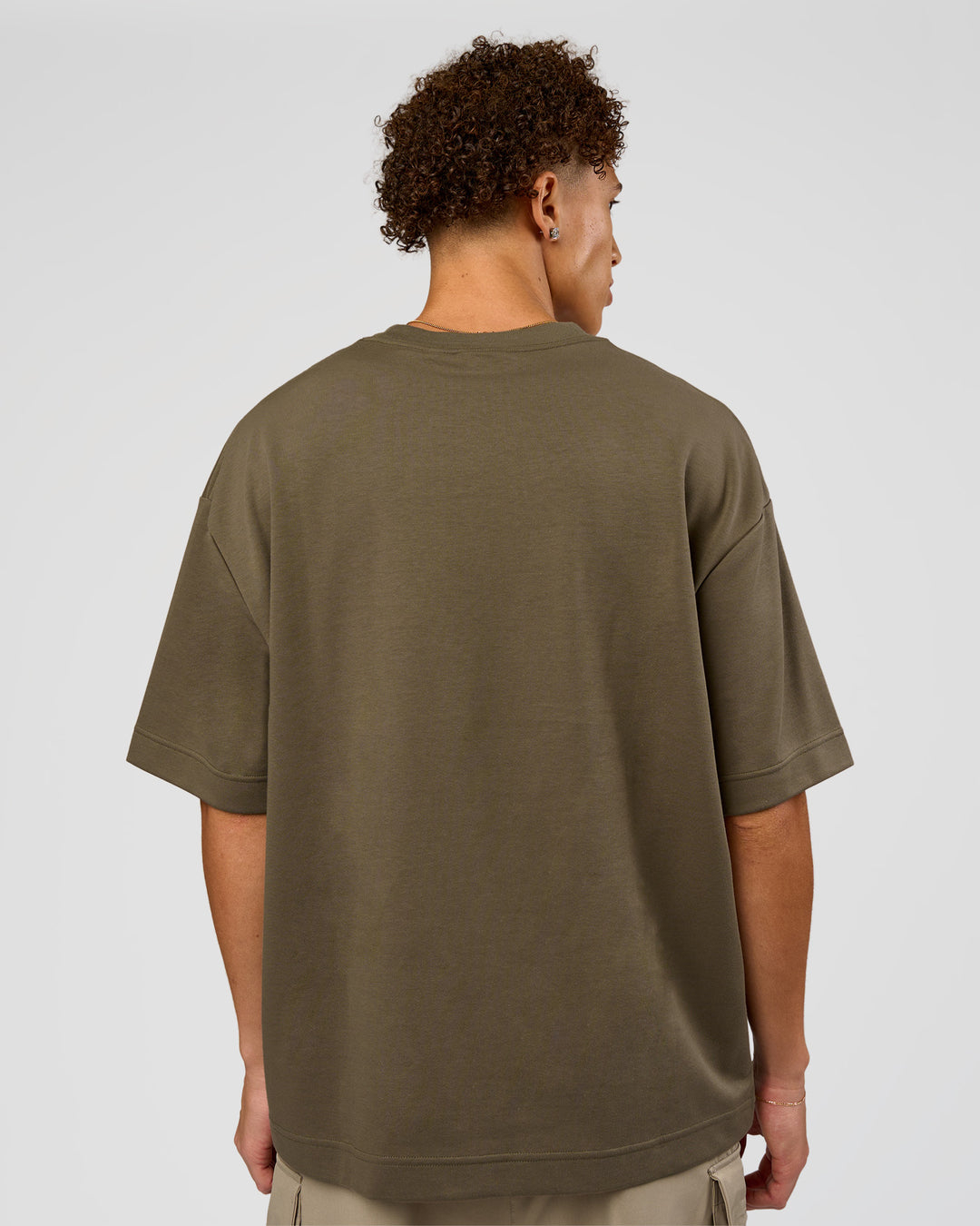 Man wearing AfterDark ZeroCrease Oversized Tee - Walnut Grey | Model:Leandro | Size:M