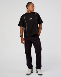 Man wearing Axis Heavyweight Oversized Boxed Tee - Black-White | Model:Malebo | Size:M