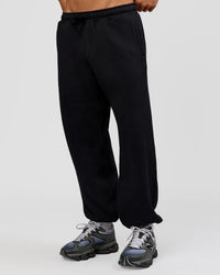 Man wearing Base Baggy Cuffed Track Pant - Black | Model:Albert | Size:M |