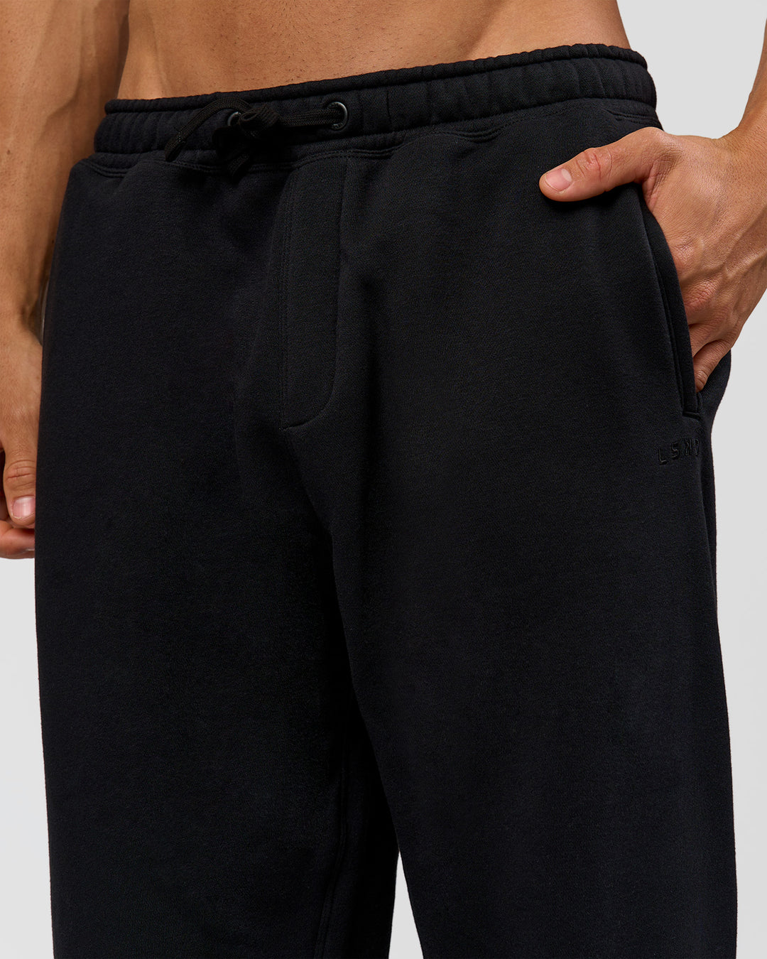 Man wearing Base Baggy Cuffed Track Pant - Black | Model:Albert | Size:M |