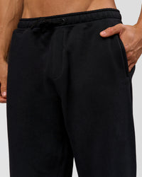 Man wearing Base Baggy Cuffed Track Pant - Black | Model:Albert | Size:M |