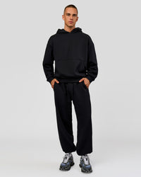 Man wearing Base Baggy Cuffed Track Pant - Black | Model:Albert | Size:M |