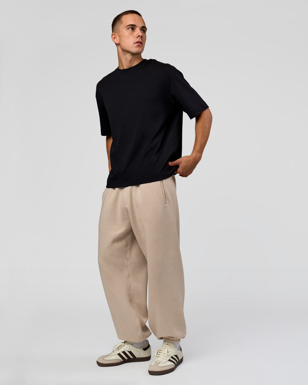 Man wearing Base Baggy Cuffed Track Pant - Shale Beige | Model:Albert | Size:M |