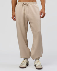 Man wearing Base Baggy Cuffed Track Pant - Shale Beige | Model:Albert | Size:M |