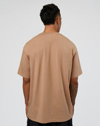 Man wearing Base FLXCotton Tee Oversized - Warm Smoke | Model:Daarian | Size:M