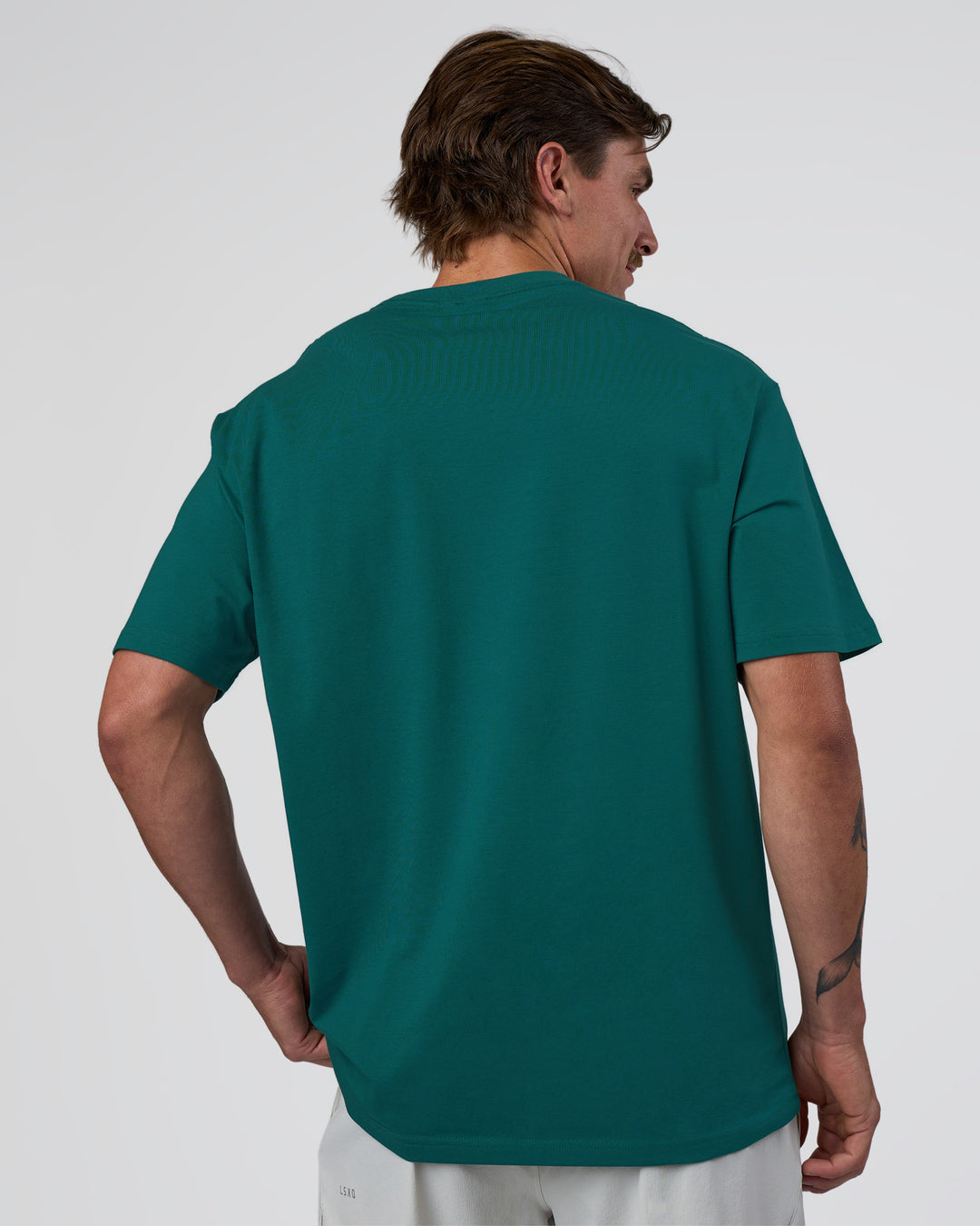 Man wearing Base FLXCotton Tee Oversized - Transformative Teal | Model:Konnor | Size:M
