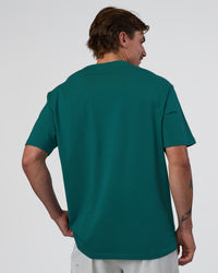 Man wearing Base FLXCotton Tee Oversized - Transformative Teal | Model:Konnor | Size:M