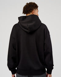 Man wearing Base Oversized Hoodie - Black | Model:Leandro | Size:M |