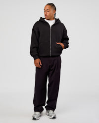 Man wearing Base Zip Through Oversized Hoodie - Black | Model:Malebo | Size:M