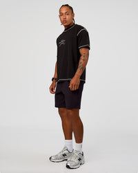Man wearing CF Unisex Oversized Heavyweight FLXCotton Tee - Black-CF Move Through It | Model:Malebo | Size:M
