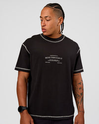Man wearing CF Unisex Oversized Heavyweight FLXCotton Tee - Black-CF Move Through It | Model:Malebo | Size:M