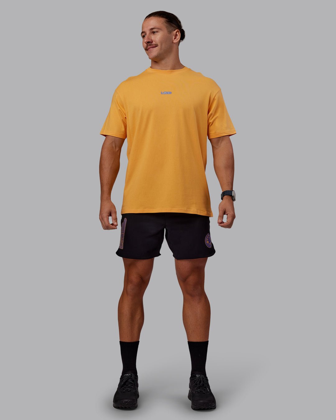 Man wearing CFT BNE 25 FLXCotton Oversized Tee - Warm Apricot-Purple Opulence | Model:Jaiden | Size:M