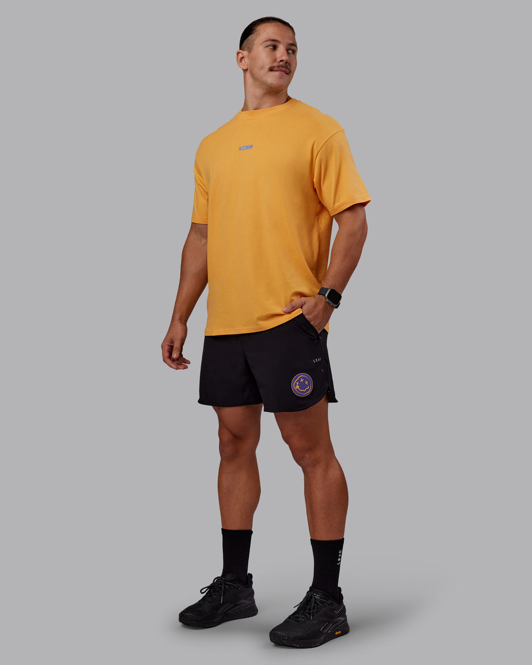 Man wearing CFT BNE 25 FLXCotton Oversized Tee - Warm Apricot-Purple Opulence | Model:Jaiden | Size:M