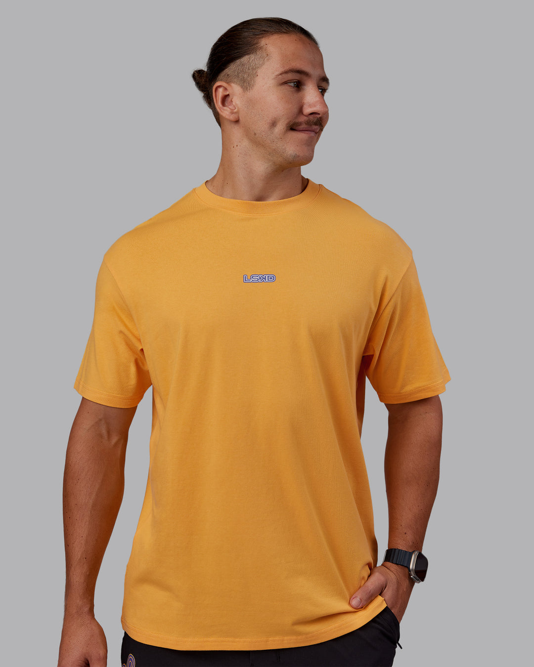 Man wearing CFT BNE 25 FLXCotton Oversized Tee - Warm Apricot-Purple Opulence | Model:Jaiden | Size:M