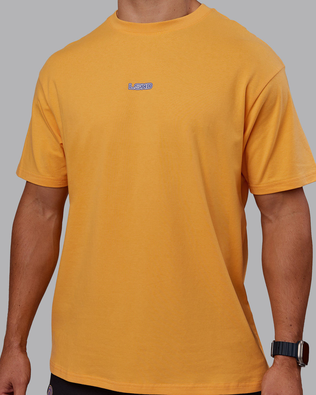 Man wearing CFT BNE 25 FLXCotton Oversized Tee - Warm Apricot-Purple Opulence | Model:Jaiden | Size:M