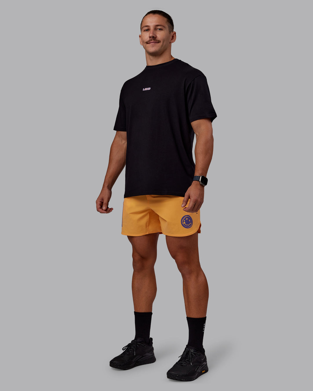 Man wearing CFT BNE 25 Lift 6&quot; Short - Warm Apricot-Purple Opulence | Model:Jaiden | Size:M