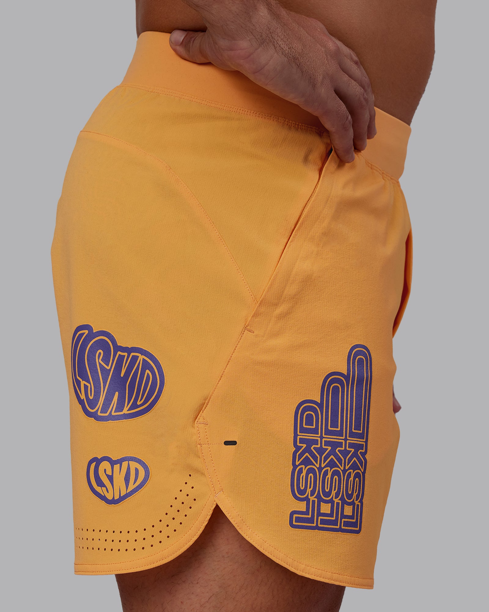 Man wearing CFT BNE 25 Lift 6" Short - Warm Apricot-Purple Opulence | Model:Jaiden | Size:M